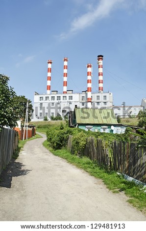Industrial building on a background of the village. Past and present. Ancient and modern. Gomel, Belarus
