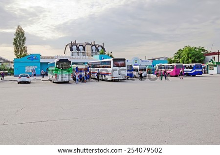 FEODOSIA, CRIMEA, RUSSIA - JUNE 08: Buses and people are waiting for the departure from the central bus station on June 08, 2014 in Feodosia, Crimea, Russia