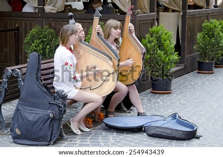 LVOV, UKRAINE - JUNE 13: Street musicians in the center of Lvov entertain tourists on June 13, 2012 in Lvov, Ukraine