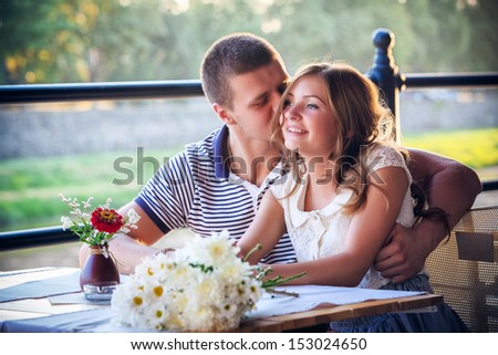 young couple in an open-air cafe