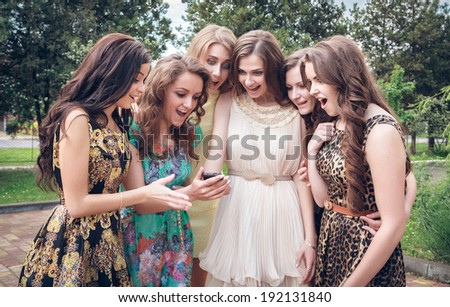 Group of girls looking at a cell phone