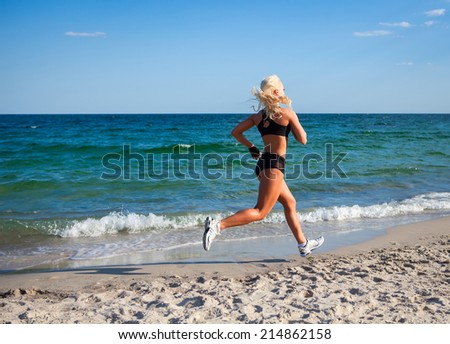 Running woman. Female runner jogging during outdoor workout on beach