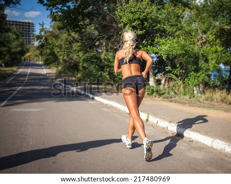 young woman jogging in the park in summer