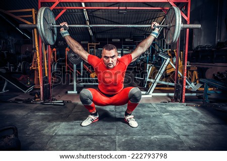 Powerlifter with strong arms lifting weights