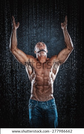 very muscular handsome athletic man in the rain