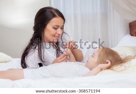 Happy Mother and daughter in bed