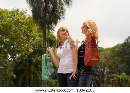 Two women with food bags against the nature