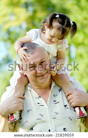 The grandfather with grand daughter in park