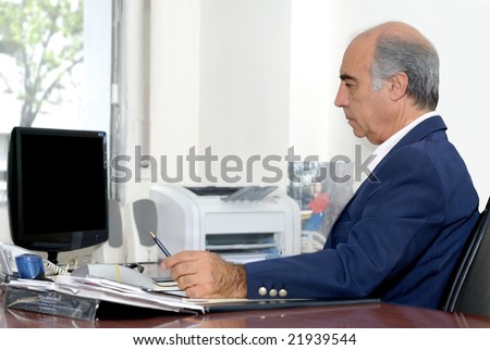 The elderly businessman on a workplace