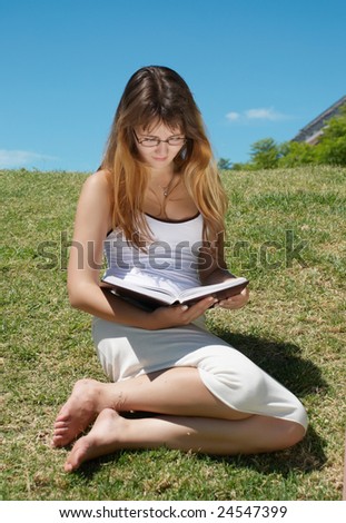 The student with the book  in park