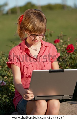 The schoolgirl with laptop in park
