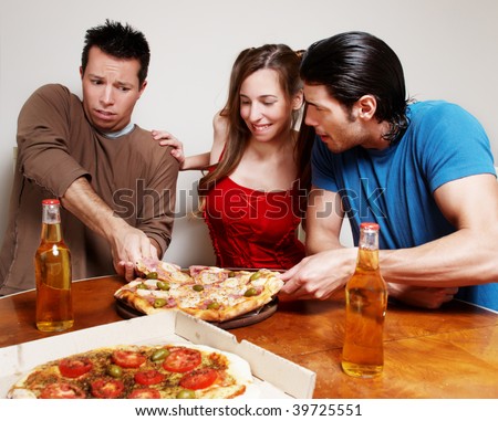 The cheerful company of youth eating a pizza