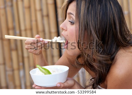 Beautiful woman eating rice