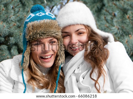 Two cheerful girls twins, in the park