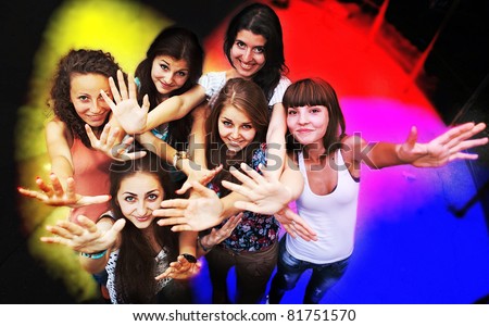 Group of young friends dancing at a night club