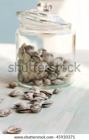 Some dried apricot stones and glass jar