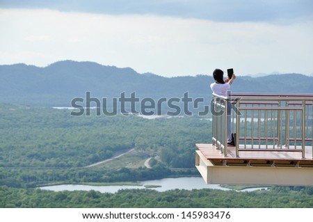 Woman on top view of a  enjoying valley view