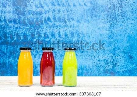 Juice bottle on vintage wooden background