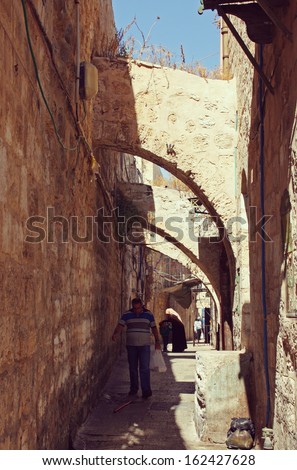 Jerusalem, Israel - October 1, 2013: Old men walking in a litlle street of the old town of Jerusalem. old town of jerusalem.