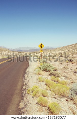 Curved road sign in Death Valley National Park, USA