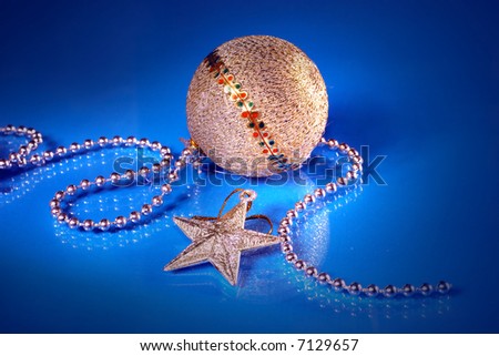 christmas ball and star on the sparkling blue background
