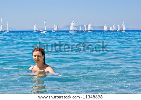 Swimming Woman and sails in the background