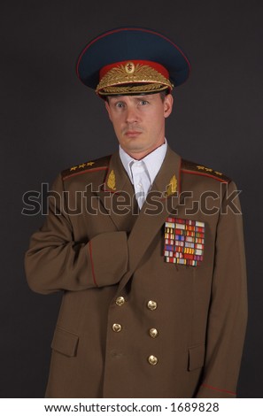 Portrait of a man dressed in a military uniform, with his hand inside his jacket