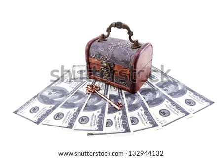 Treasure chest with an old skeleton key upon US paper currency isolated on white/Money under protection