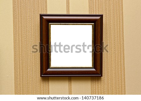 Hanging empty photo frame on a retro wall with striped wallpapers/Hanging empty photo frame
