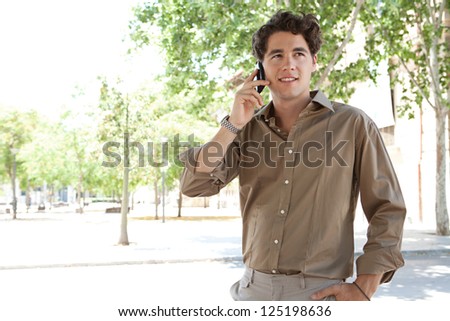 Portrait of a smart businessman having a phone conversation on his \