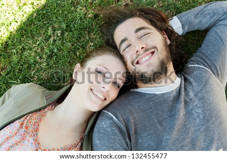 Over Head Close Up Portrait Of A Young Bohemian Couple Laying Down On ...