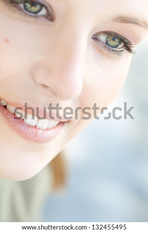 Close up beauty portrait of a young caucasian healthy woman face and eye looking down with long eyelashes.