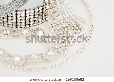 Close up still life view of exclusive and luxurious diamond bracelets, engagement rings, necklaces and earrings. A multiple quality diamond detail jewelry shining and sparkling with light, interior.