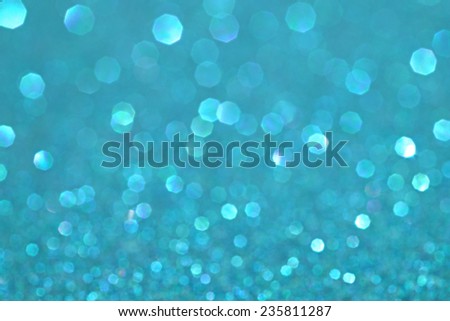 Abstract blurry blue cyan glitter festive background texture with shining glittering stars. Full frame magenta color christmas detail with blurred areas. Artistic colorful background drop frame space.