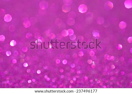 Abstract blurry pink glitter festive background texture with shining glittering stars. Full frame magenta color christmas detail with blurred areas. Artistic colorful background drop frame space.