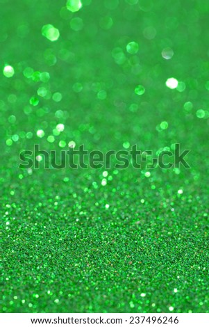 Abstract green glitter festive background texture with shining glittering stars. Full frame magenta color christmas detail with blurred areas. Artistic colorful background drop frame space.