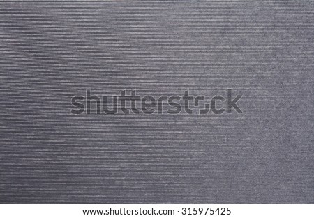 Black and white still life paper sheet texture background with horizontal lines, full frame. Close up detail of a textured blank page with monotone dark gray organic art paper. Background stripes.