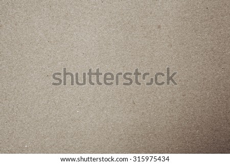 Light brown still life paper sheet texture background with grain noise dirt and specs effect, full frame. Close up detail of a textured blank page monotone color organic art paper. Beige background.