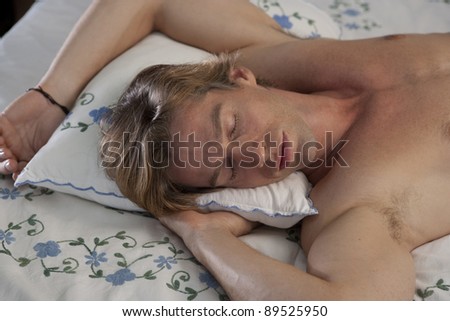 Young man sleeping in bed.