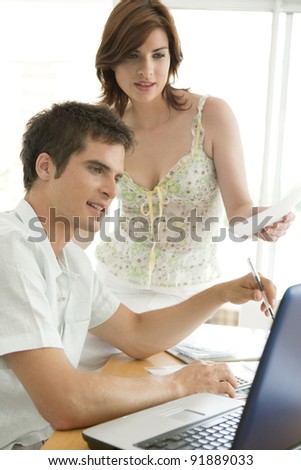 Man and woman working together in office room.