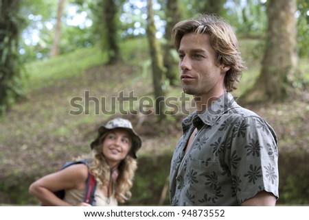 Man and woman trekking in the woods.