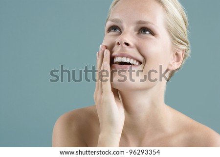 Close up portrait of a woman\'s face laughing.