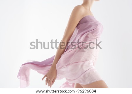 Close up of a woman\'s body wearing a floaty sarong.