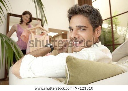 Woman trying clothes on in fashion store with boyfriend.