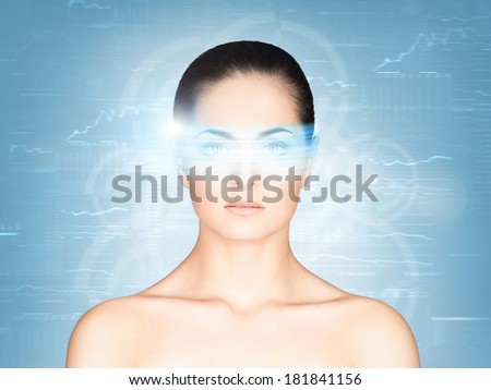 Young and attractive woman from future with the laser hologram on her eyes (eye scanning technology, optometry and virtual reality concept)