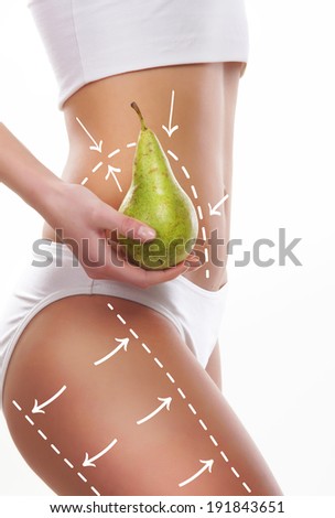 Female body with the drawing arrows on it isolated on white. Woman holding pear. Fat lose, liposuction and cellulite removal concept.