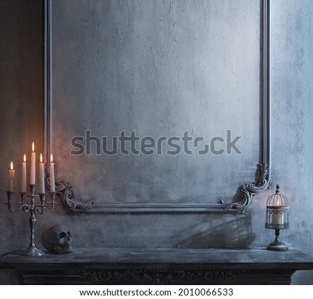 Mystical Halloween still-life background. Skull, candlestick with candles, old fireplace. Horror and witchery. 商業照片 © 