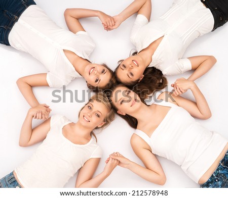 Large group of smiling teenage friends looking at camera isolated on white