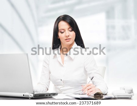 Young and attractive business woman working in office