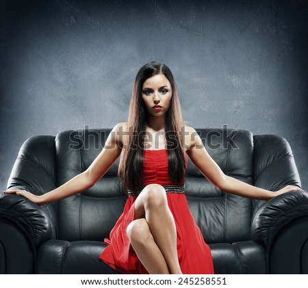 https://image.shutterstock.com/display_pic_with_logo/84070/245258551/stock-photo-young-woman-in-red-evening-dress-sitting-on-the-black-leather-sofa-over-grey-background-245258551.jpg
